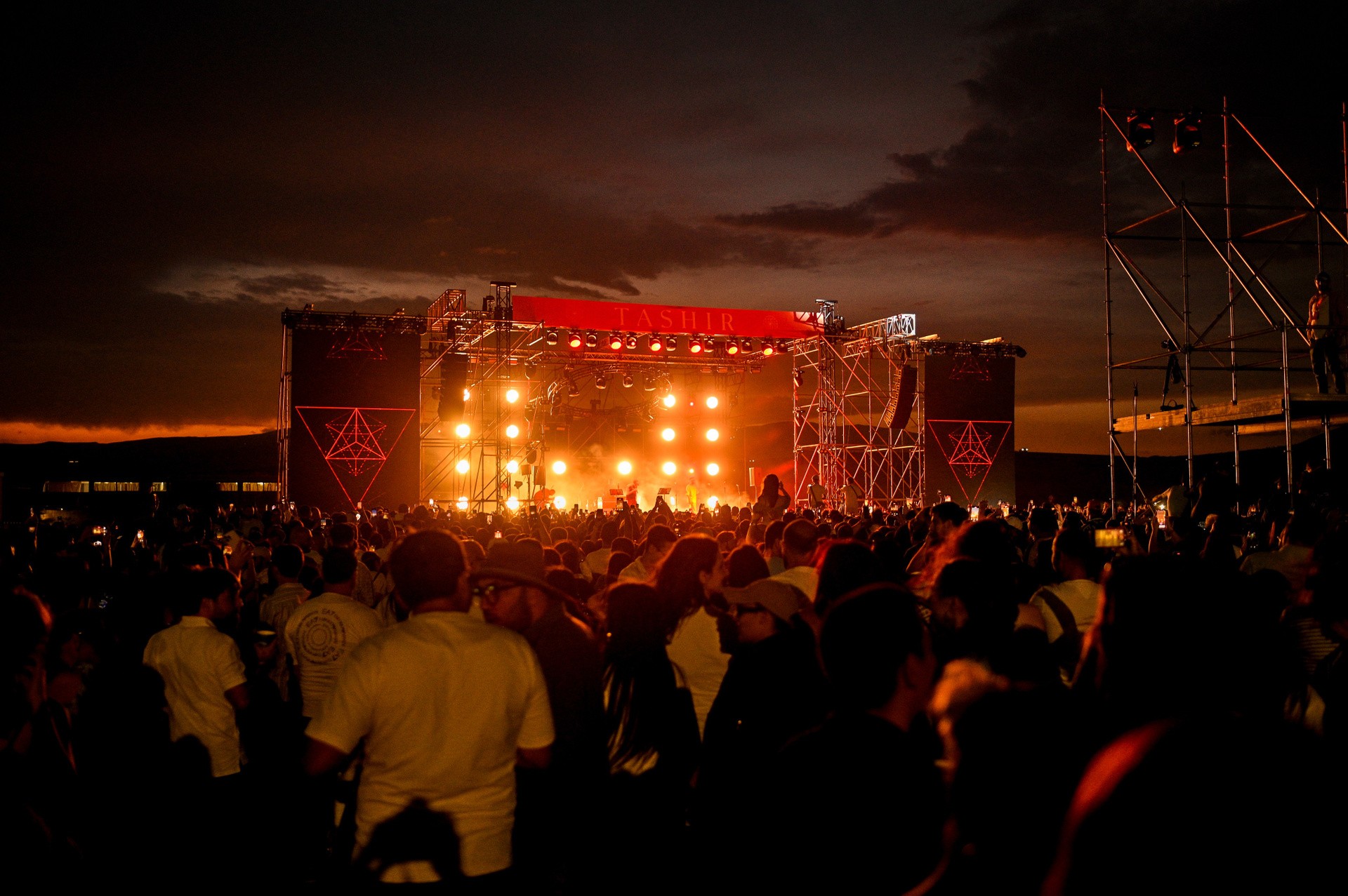 Aerial view of Festival Arevod at sunset — crowd, geodesic domes and main stage