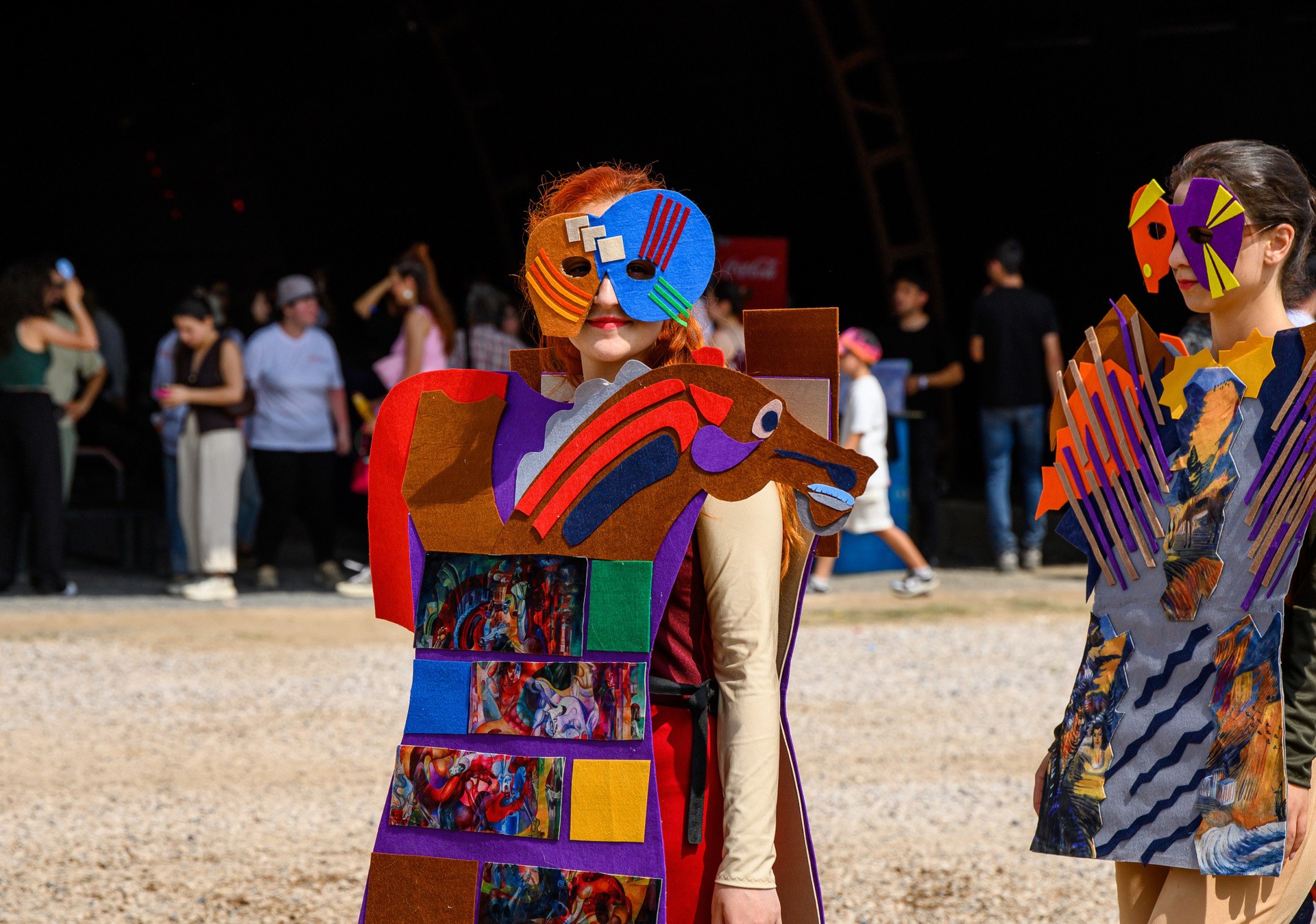 Festival-goers in handmade art costumes and masks