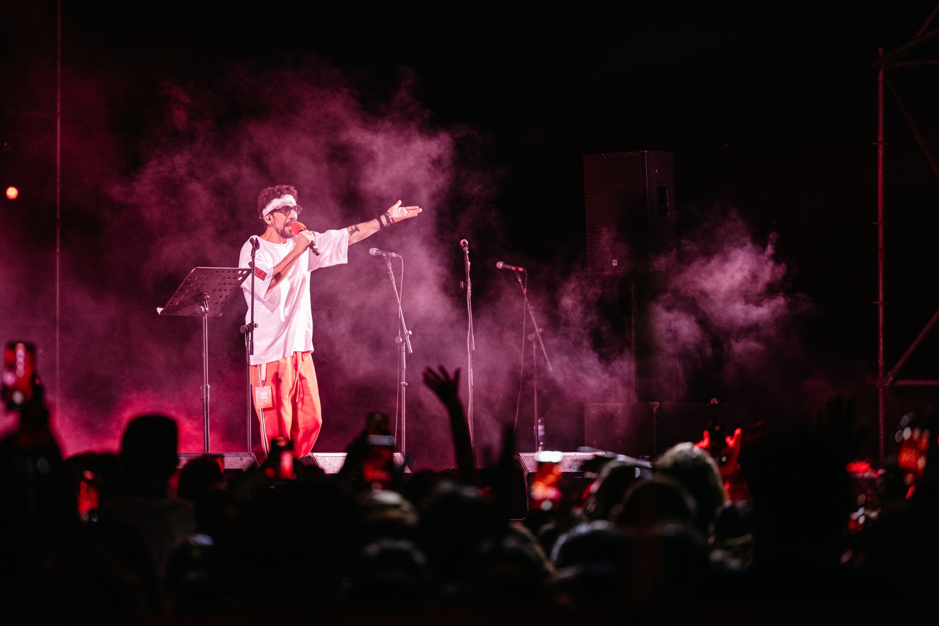 Performer on stage in pink smoke