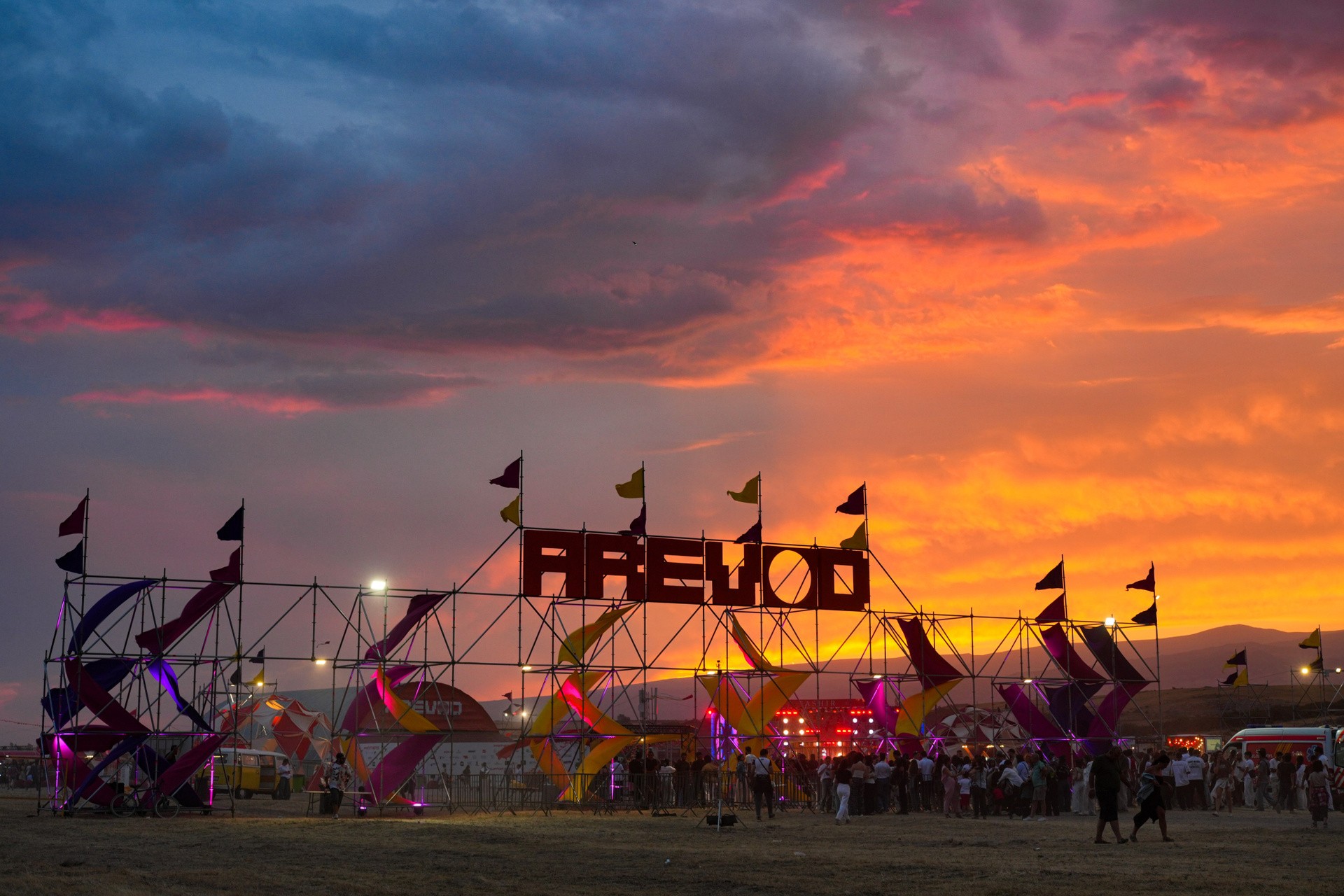 AREVOD entrance sign silhouetted against a dramatic sunset