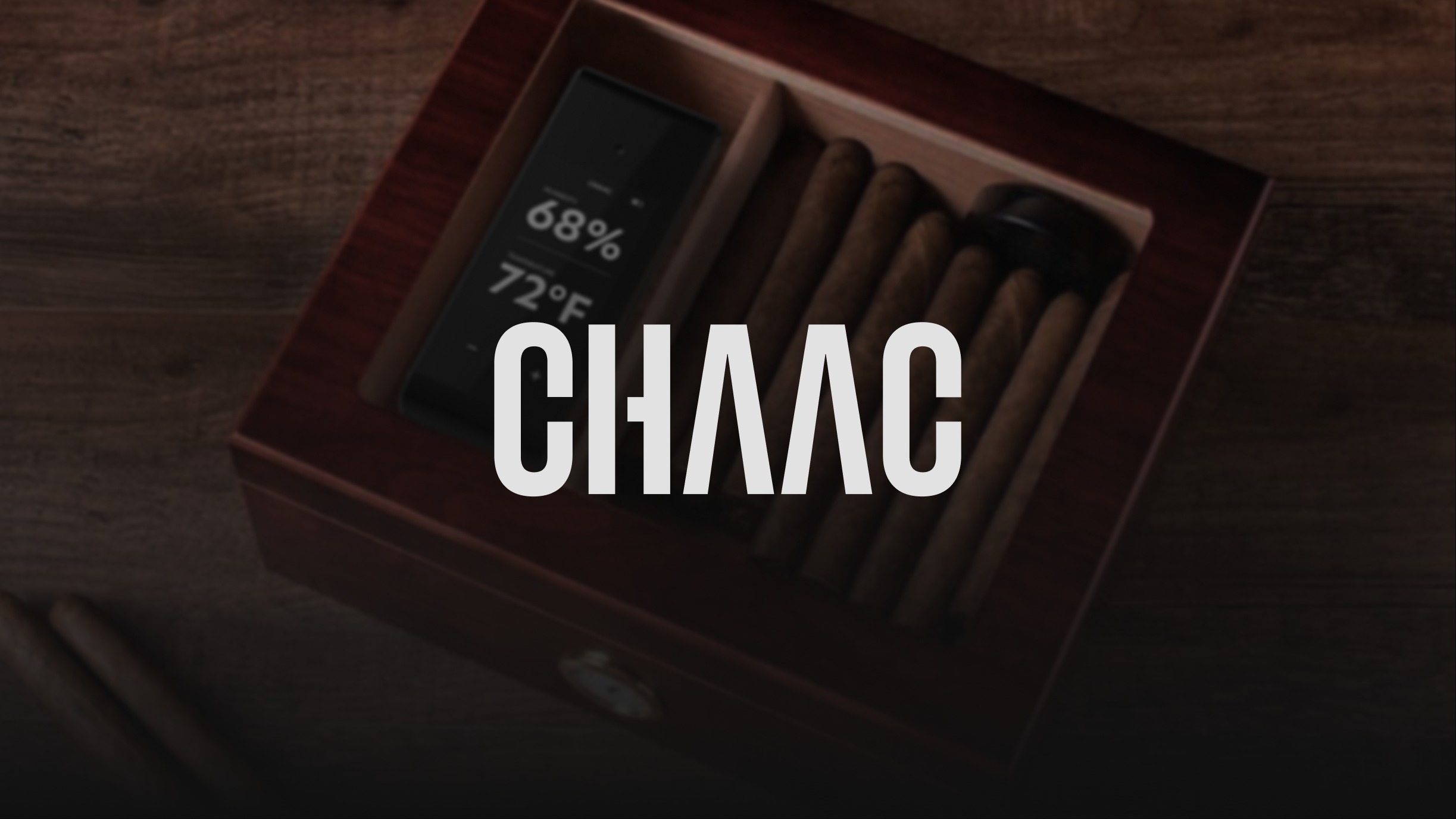 Chaac wordmark over an open humidor with device and cigars