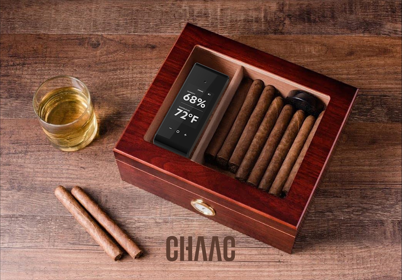 Chaac humidor on a wood table with whiskey and cigars