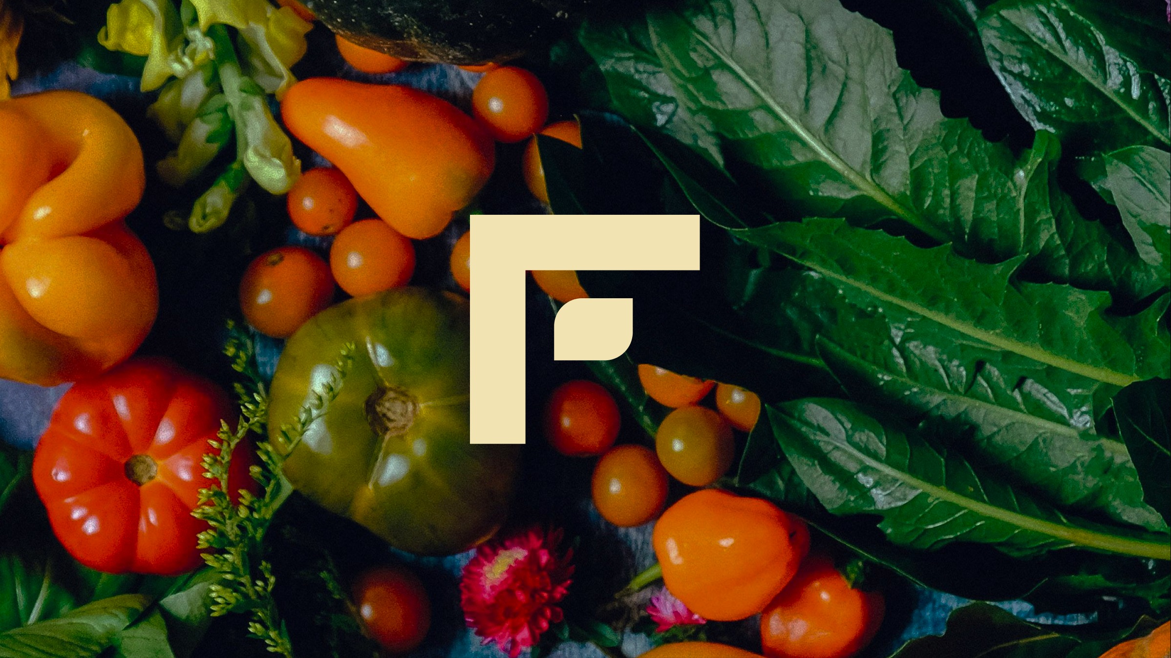 Harvest Fresh F mark over fresh produce and greens