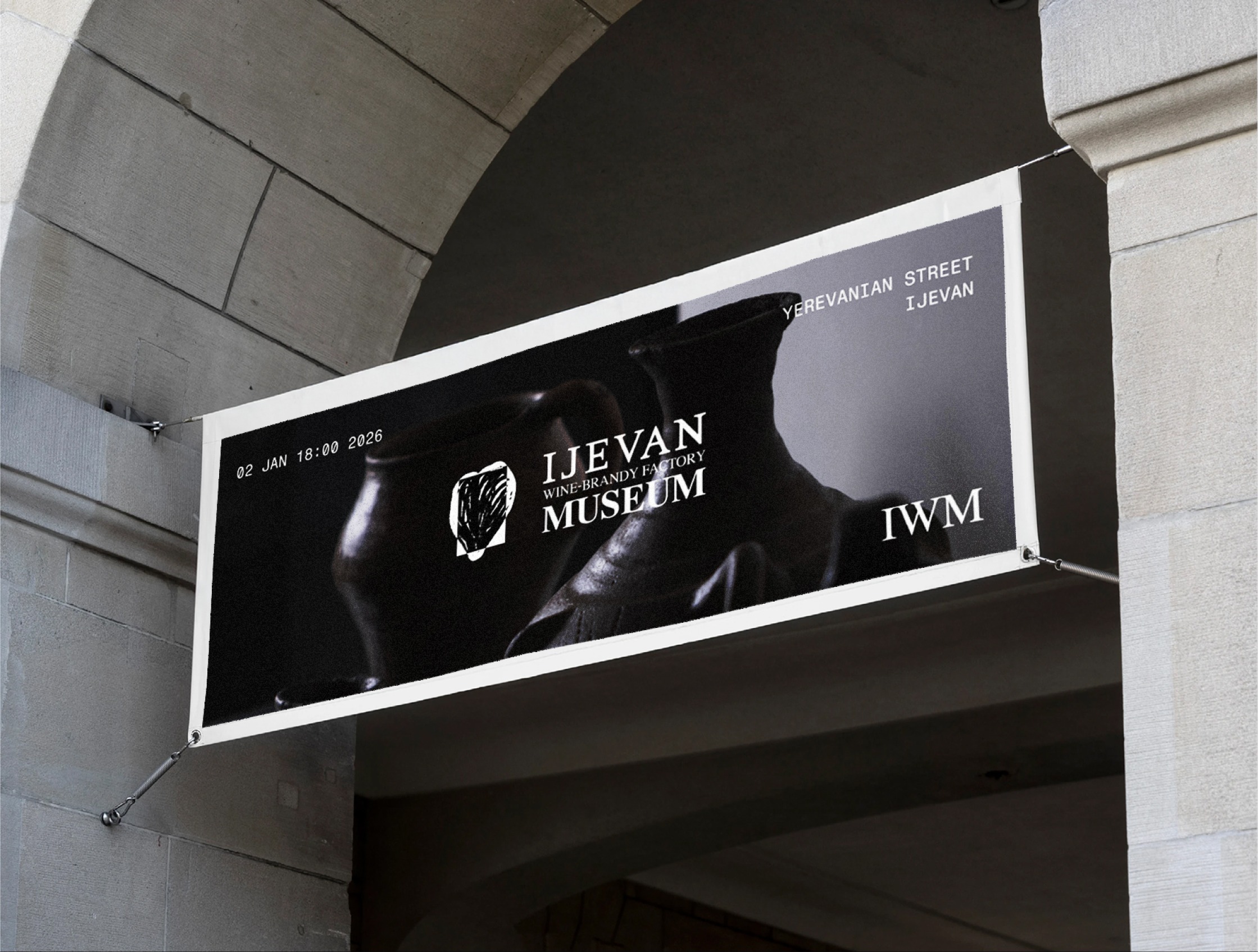 Ijevan Museum branded banner installed under a stone archway entrance