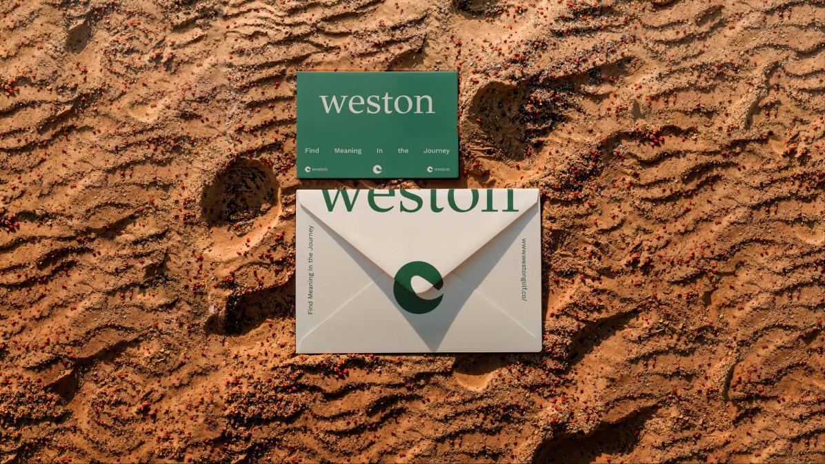 Weston business card and envelope on sand