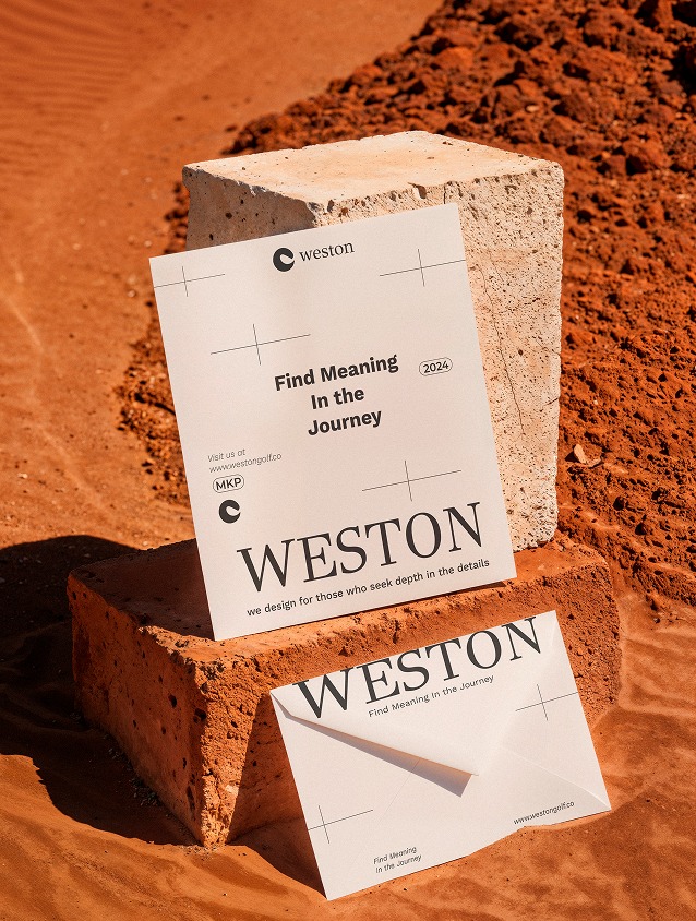 Weston business card and envelope on a stone block